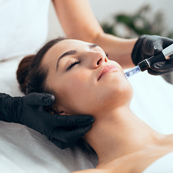 Shot of cosmetologist making mesotherapy injection with dermapen on face for rejuvenation on the spa center.